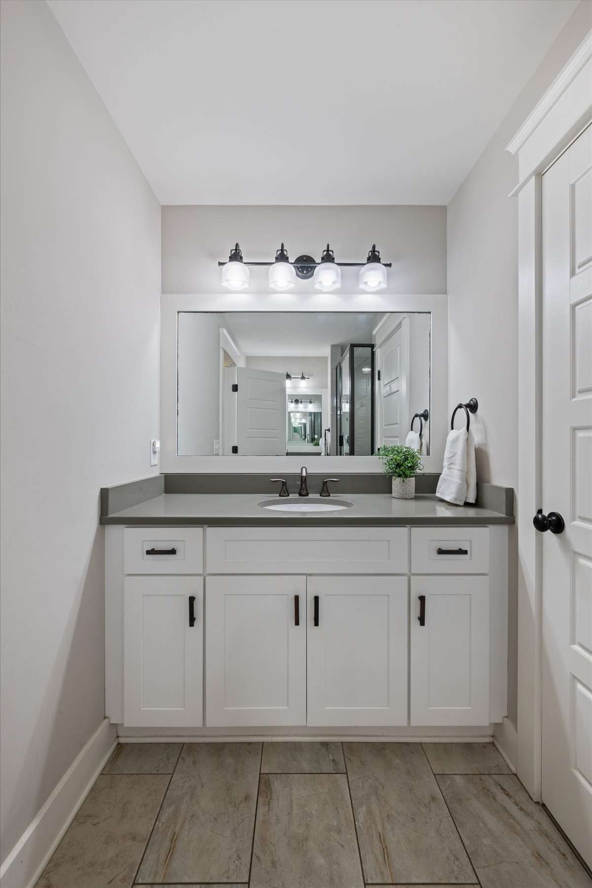 2nd primary bathroom with double vanities and a walk in shower
