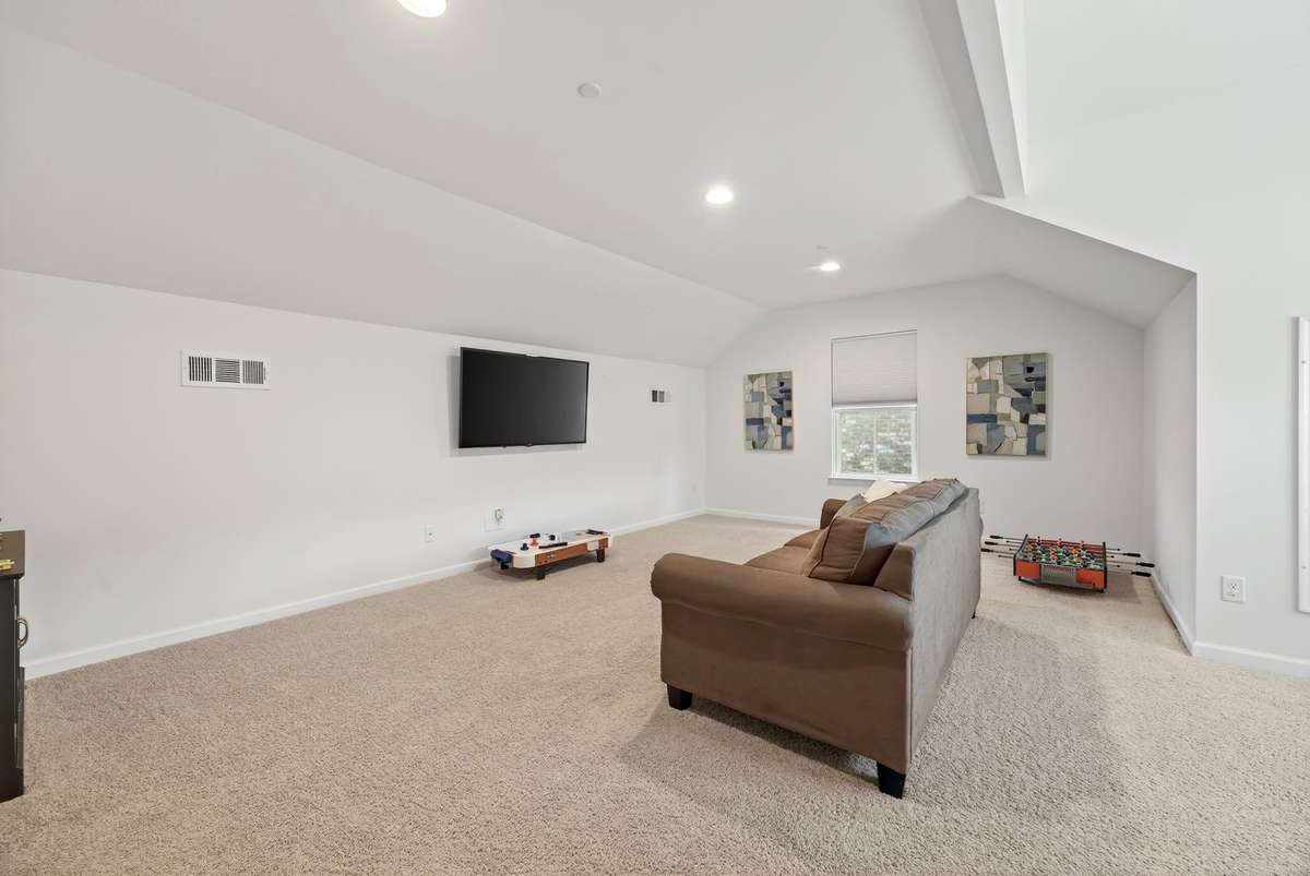 The massive second-level bonus room is the ultimate flexible space, perfectly sized for a media center, home gym, game room, or play area, all illuminated by recessed lighting.