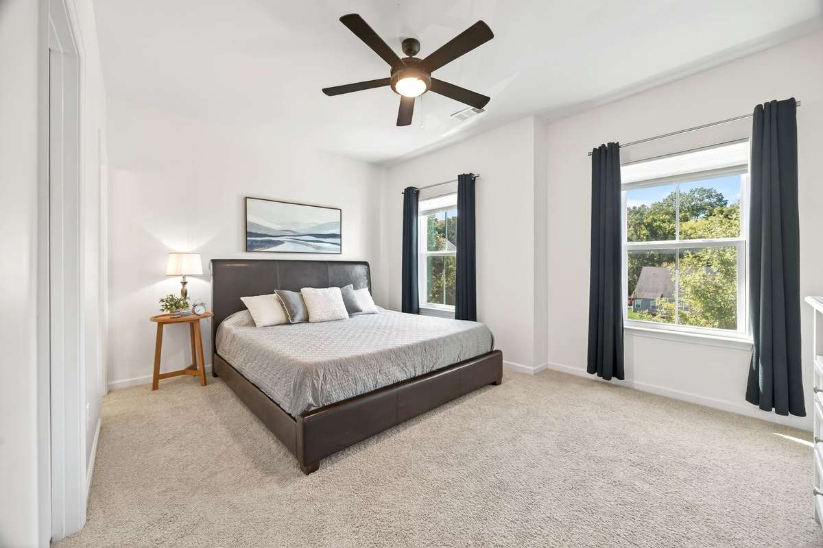 There are three additional bedrooms on the second level. This guest suite is complete with a walk-in closet and en suite full bath.