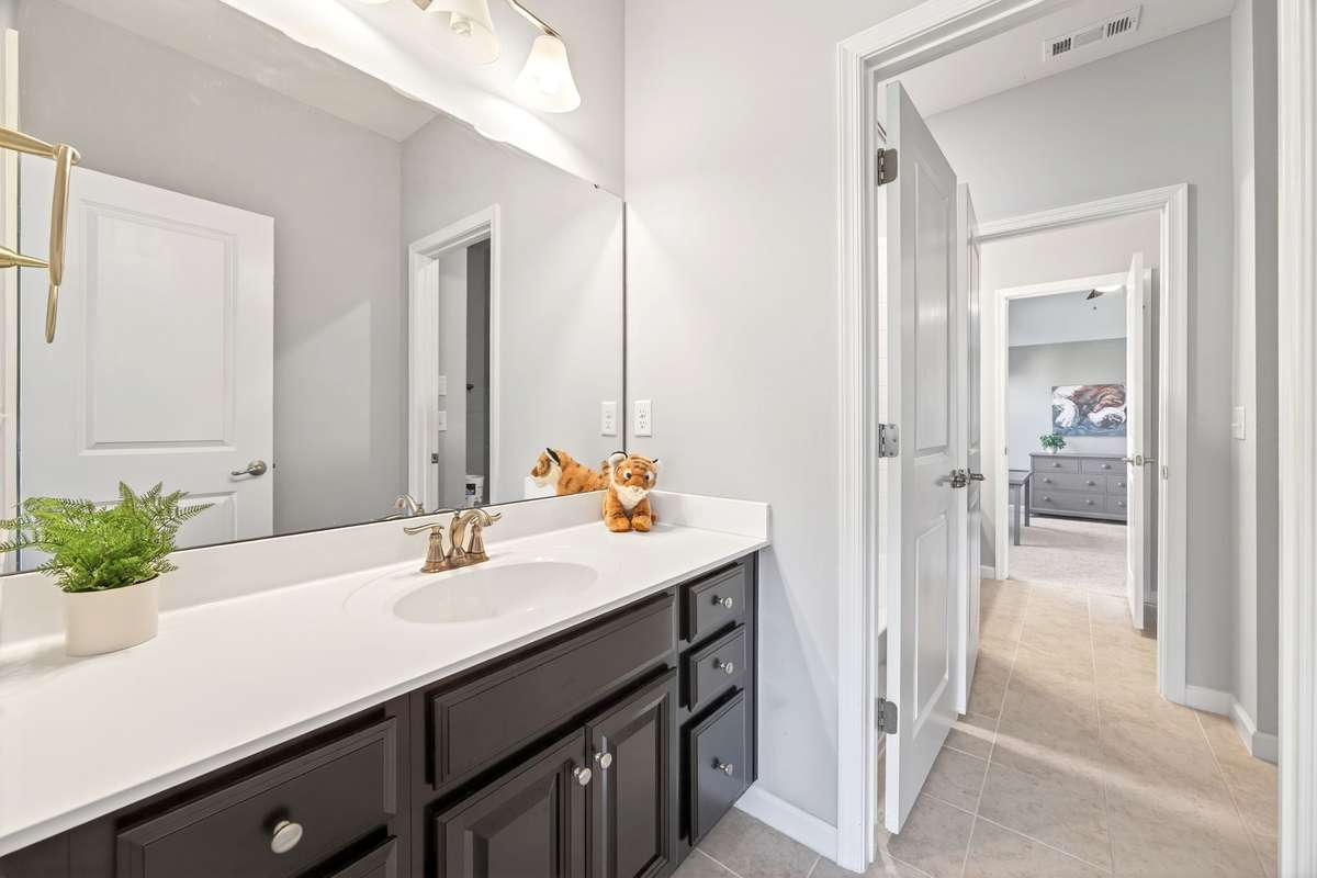 Situated between two bedrooms, this innovative bath provides separate, private vanity areas while sharing a central tub/shower room, eliminating morning congestion.