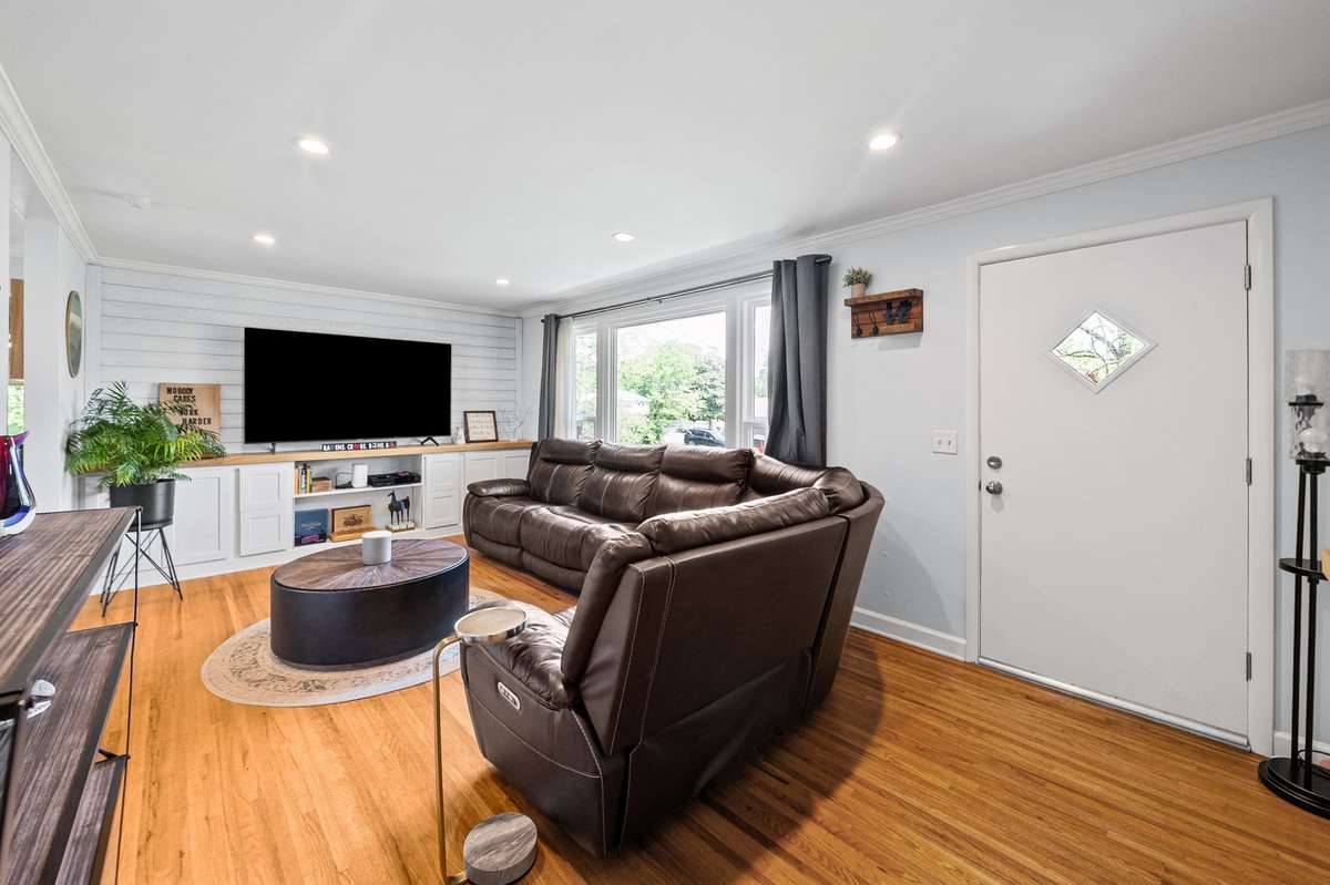 Living room offers built ins and a beautiful window for plenty of natural light.
