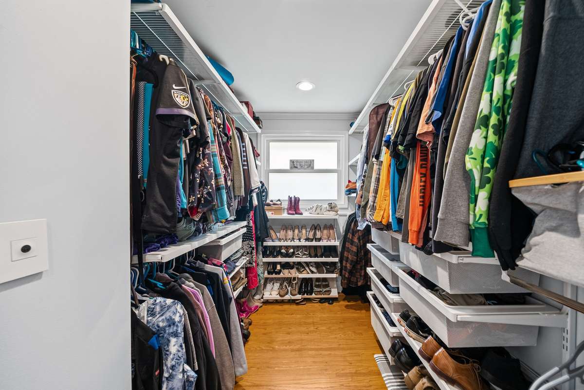 The Primary bedroom suite offers a dream closet with built in shelving and renovated bathroom with oversized shower.