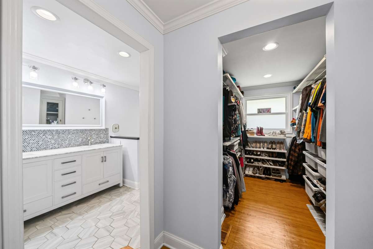 The Primary bedroom suite offers a dream closet with built in shelving and renovated bathroom with oversized shower.