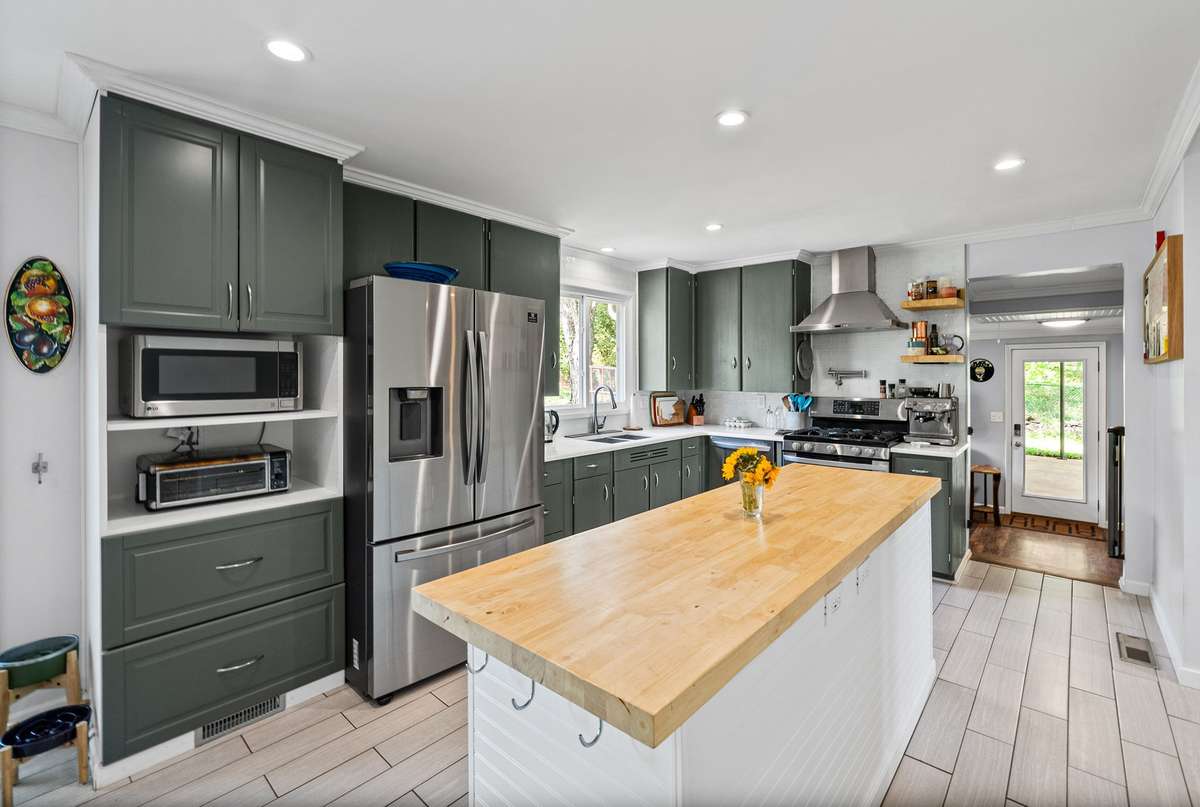 The heart of the home! Spacious and updated kitchen with island and eat in dining area.