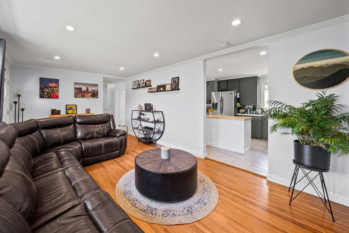 Living room offers built in shelving and large windows offering plenty of natural light.