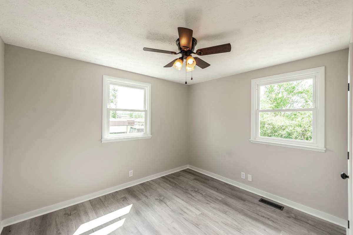 Fresh luxury vinyl plank flooring continues throughout, providing a clean, cohesive look across all bedrooms.