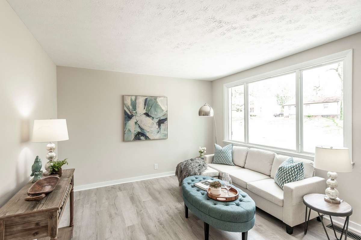 Fresh luxury vinyl plank flooring runs throughout the living area, adding durability, style, & a cohesive modern feel.