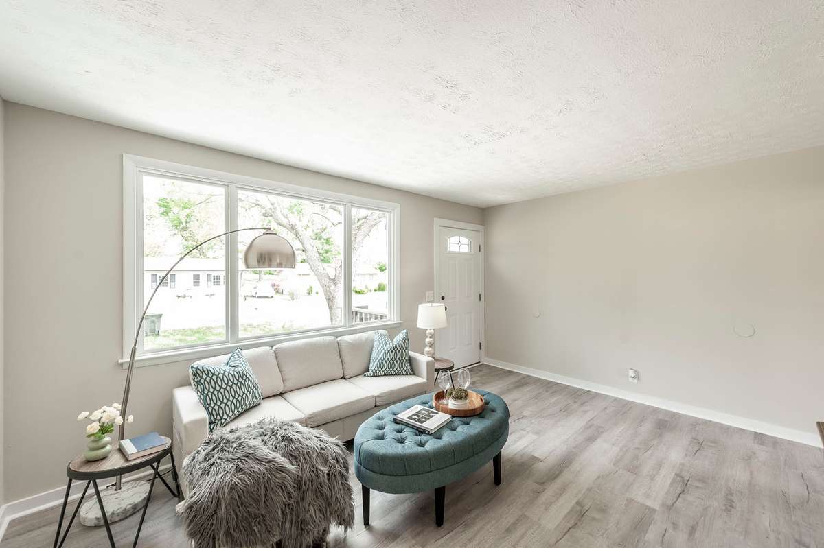 The oversized window not only brightens the room but also frames peaceful outdoor views, enhancing the sense of openness.