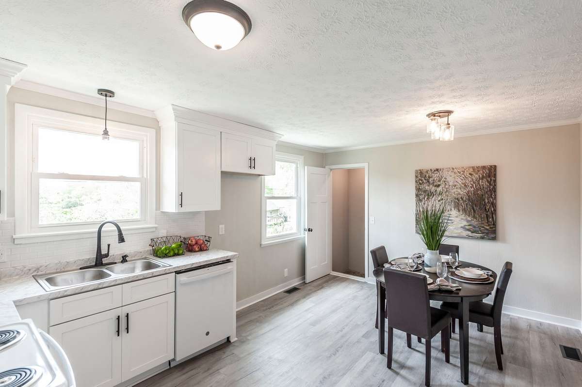 Luxury vinyl plank flooring continues seamlessly into the kitchen, tying the main level together with a cohesive look.
