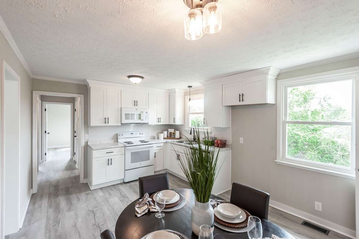 Natural light fills the area, creating a cheerful setting that feels open & connected to the kitchen.