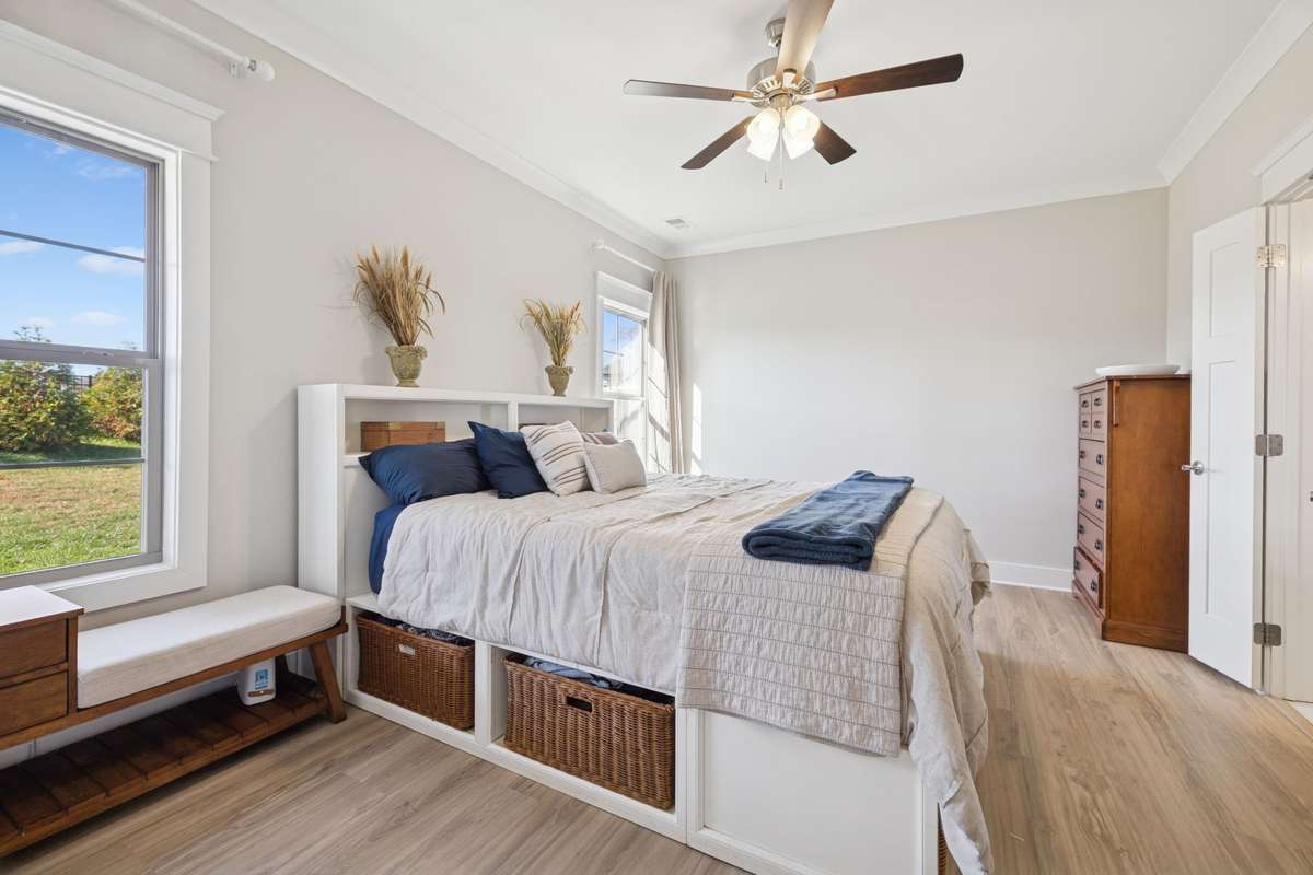 Crested with a ceiling fan and flanked by two lovely, trimmed windows, the primary bedroom offers plenty of space for all your needs.  New LVP flooring has just been installed, giving it quite the modern feel and look.