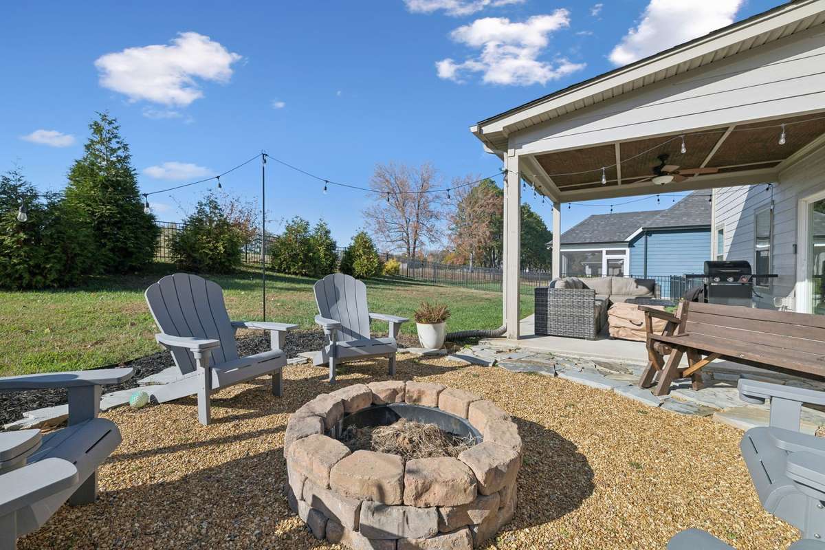 Just beyond the covered patio is this fantastic, graveled outdoor living area with a fire pit. Roasting marshmallows in the fall, summer hang time with your friends... or, maybe peace and quiet with a glass of wine...