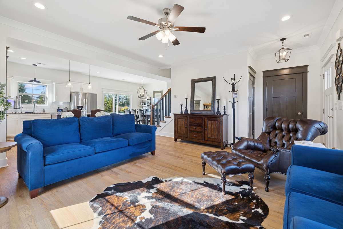 Measuring approximately 15' x 16', the living room’s nearly square layout offers versatile options for furniture arrangement and comfortable living, and it flows seamlessly into the kitchen area.