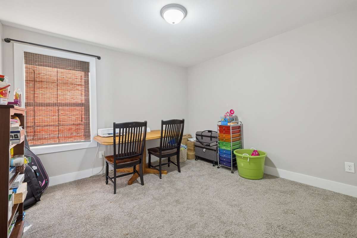 Down the hallway from the bonus room is the larger of the secondary bedrooms, measuring approximately 11' x 12'. Both bedrooms are carpeted and have one window.