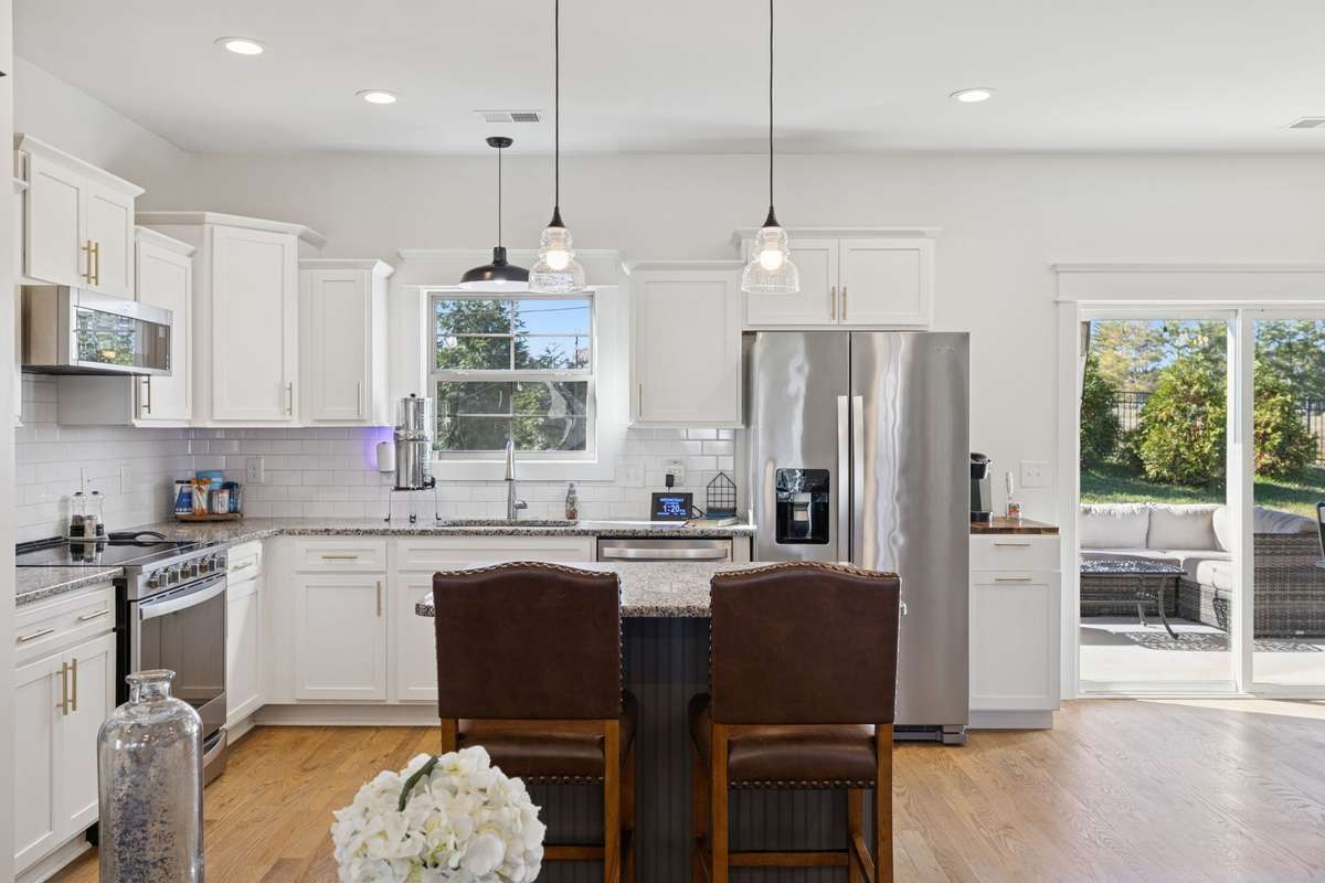 This is such a cheerful kitchen with all the natural light pouring in from the sliding glass doors and the window over the kitchen sink.  You'll have plenty of cabinet space surrounding all of the stainless steel appliances that remain with the home.
