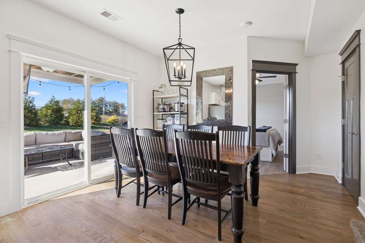 Through that open interior door, you can see how the primary bedroom is tucked away on the main level.  Very private and secluded at the rear corner of the home.