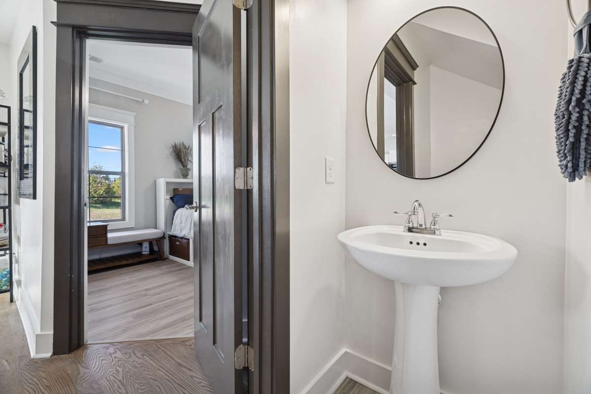 This half bath, adorned with a pedestal sink, offers privacy for your guests, away from the living area and others.  There are so many small things in this floor plan that just make great sense to a homeowner.