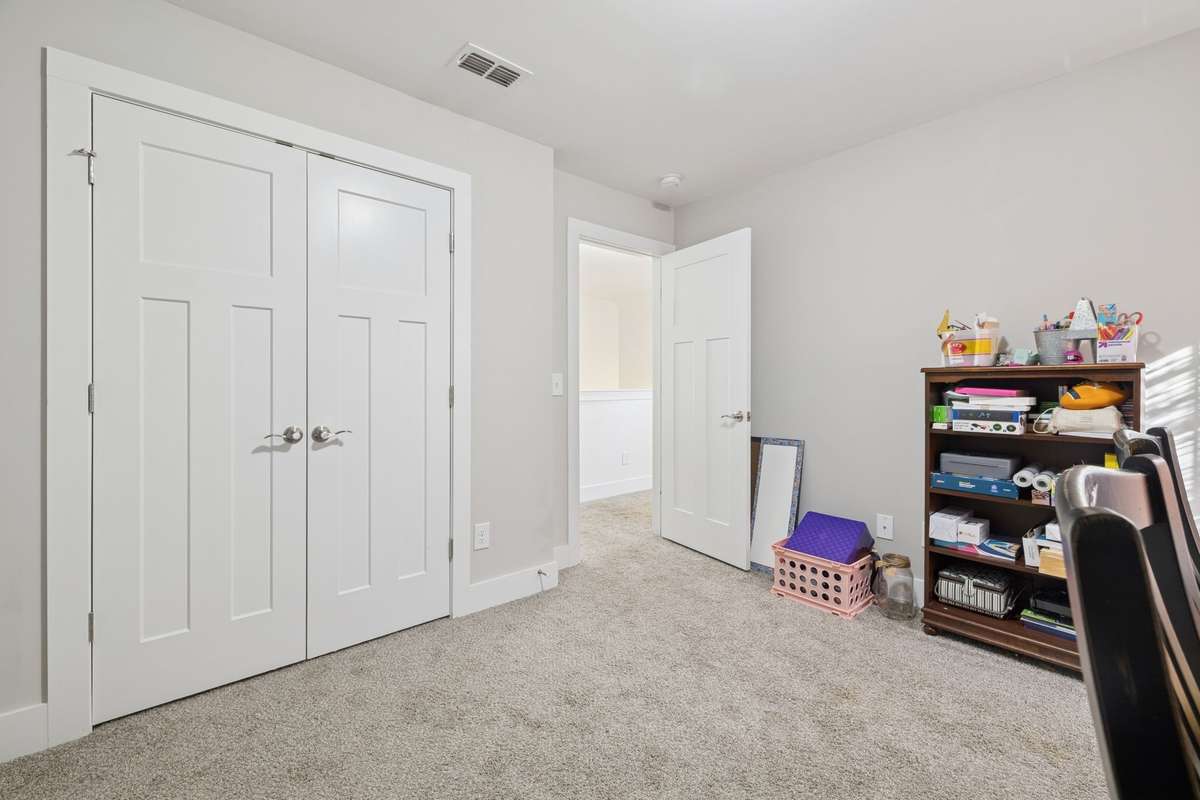 Double doors to the bedroom closet showcase the Craftsman three-panel style that complements all the interior doors in the home.