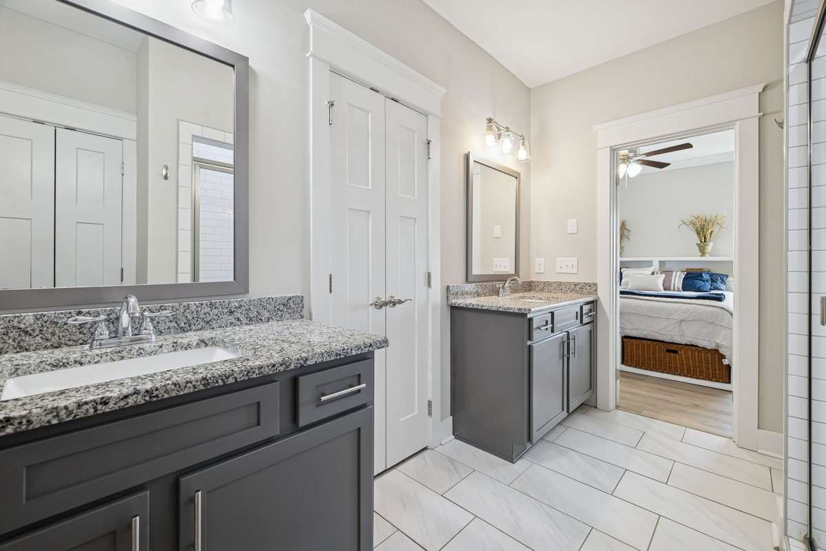 Behind those double doors in the primary bathroom is a grand walk-in closet that measures approximately 7' x 11'.  So much space! The linen closet (in the reflection) and commode flank the shower.