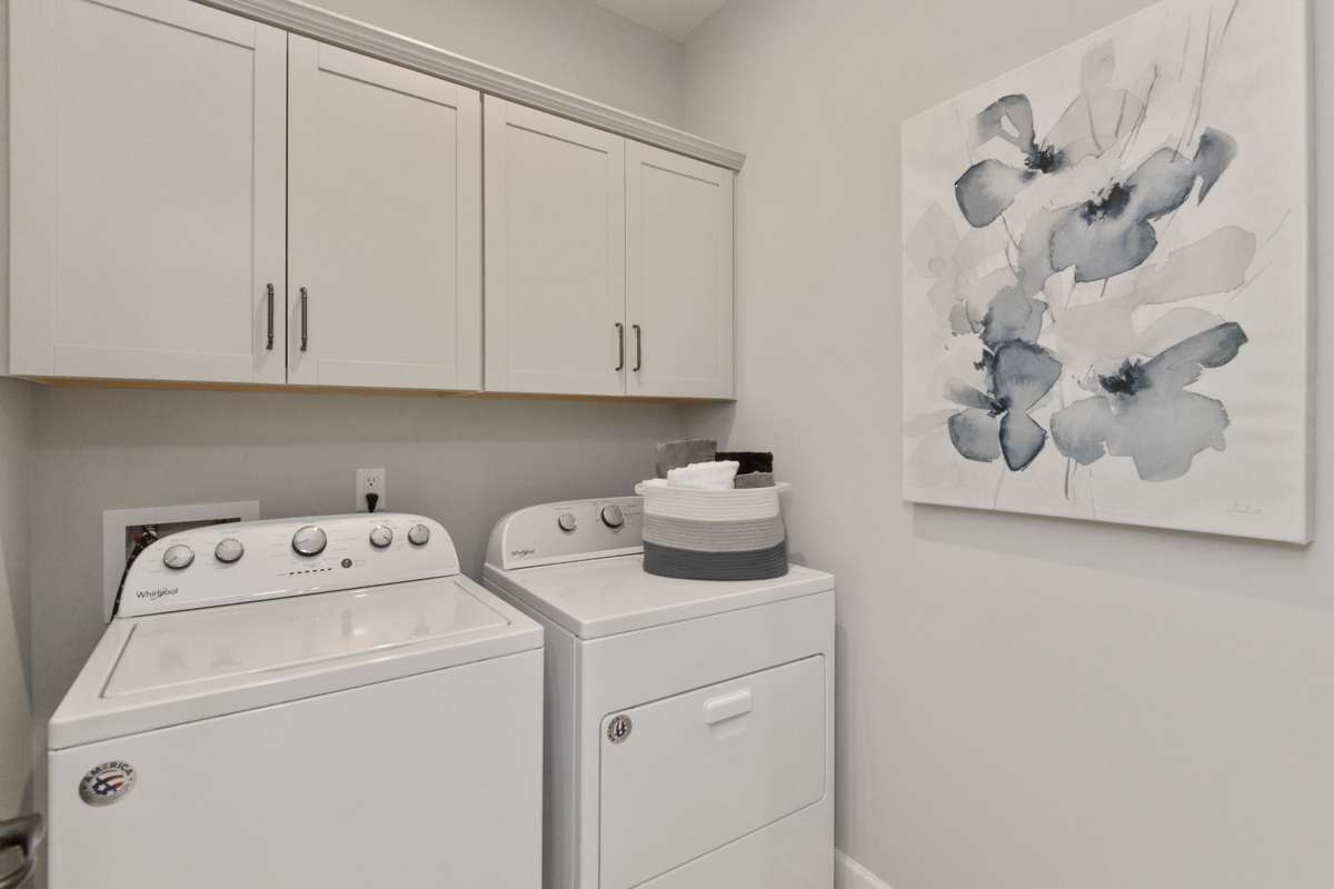 Laundry room conveniently located downstairs near primary suite.