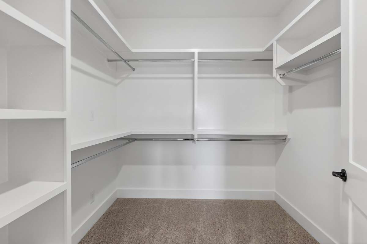 **Photos not of the actual home but of another Everleigh floor plan in The Knoll at Fairvue. Pictures to show the layout of the Owners closet on the main level staged with furniture.**