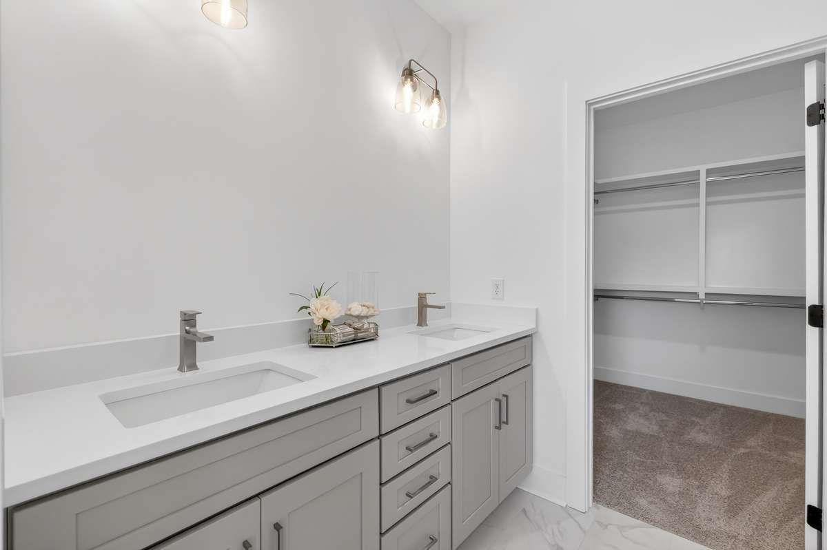 **Photos not of the actual home but of another Everleigh floor plan in The Knoll at Fairvue. Pictures to show the layout of the Owners bathroom on the main level staged with furniture.**