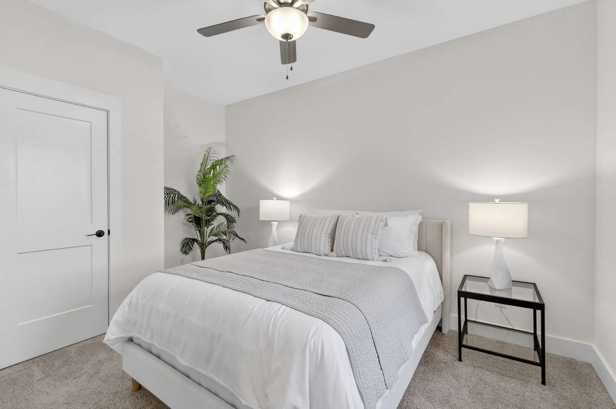 **Photos not of the actual home but of another Everleigh floor plan in The Knoll at Fairvue. Pictures to show the layout of the secondary bedroom on the main level staged with furniture.**