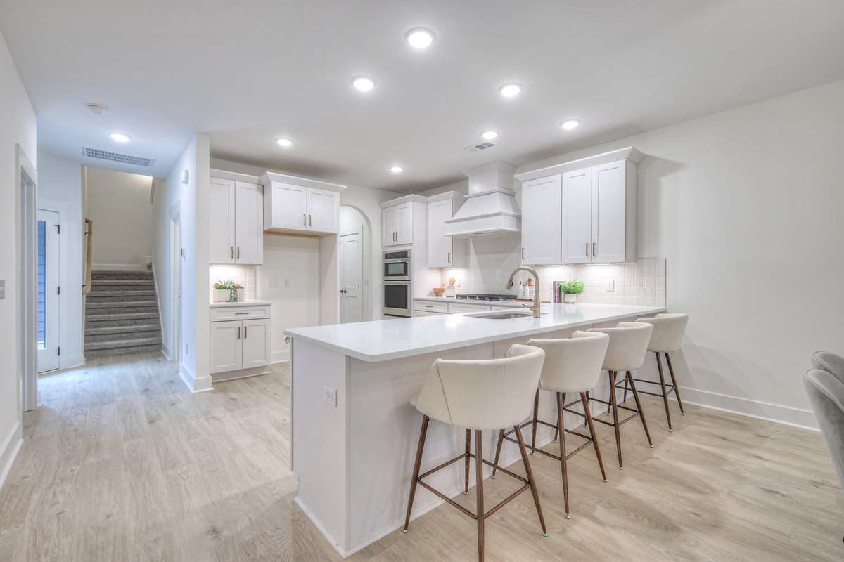 **Photos not of the actual home but of another Ashleigh floor plan in The Knoll at Fairvue. Pictures to show the layout of the kitchen staged with furniture.**
