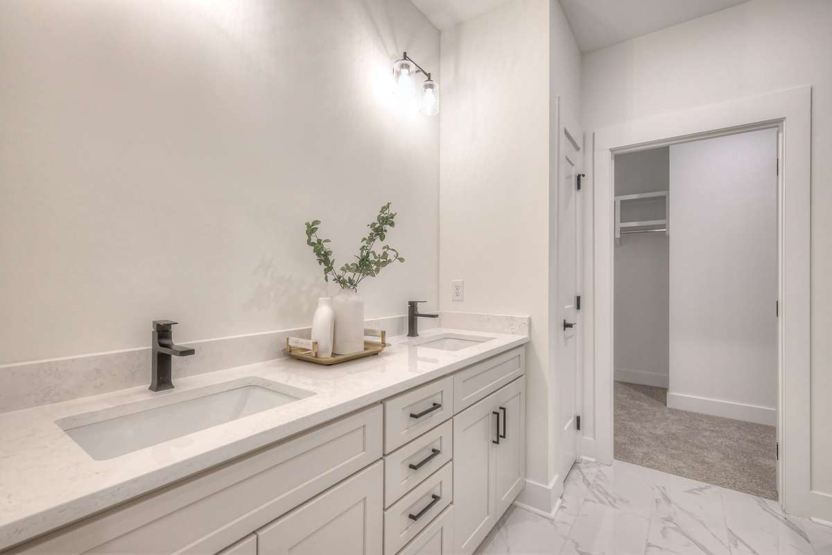 **Photos not of the actual home but of another Ashleigh floor plan in The Knoll at Fairvue. Pictures to show the layout of the Owners bathroom on the main level staged with furniture.**
