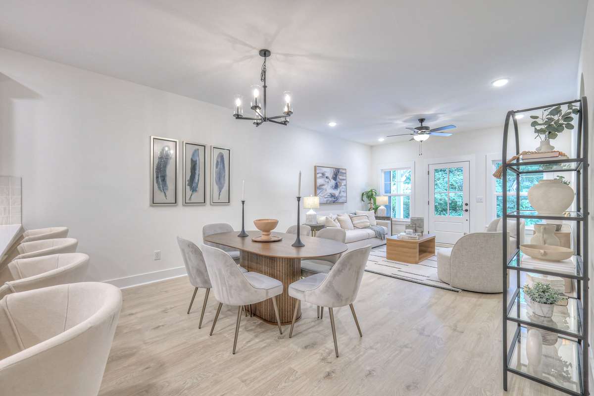 **Photos not of the actual home but of another Ashleigh floor plan in The Knoll at Fairvue. Pictures to show the layout of the living room and dining room staged with furniture.**
