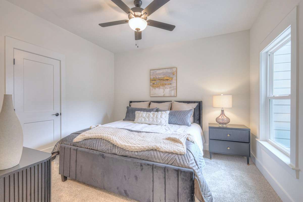 **Photos not of the actual home but of another Ashleigh floor plan in The Knoll at Fairvue. Pictures to show the layout of the secondary bedroom on the main level staged with furniture.**