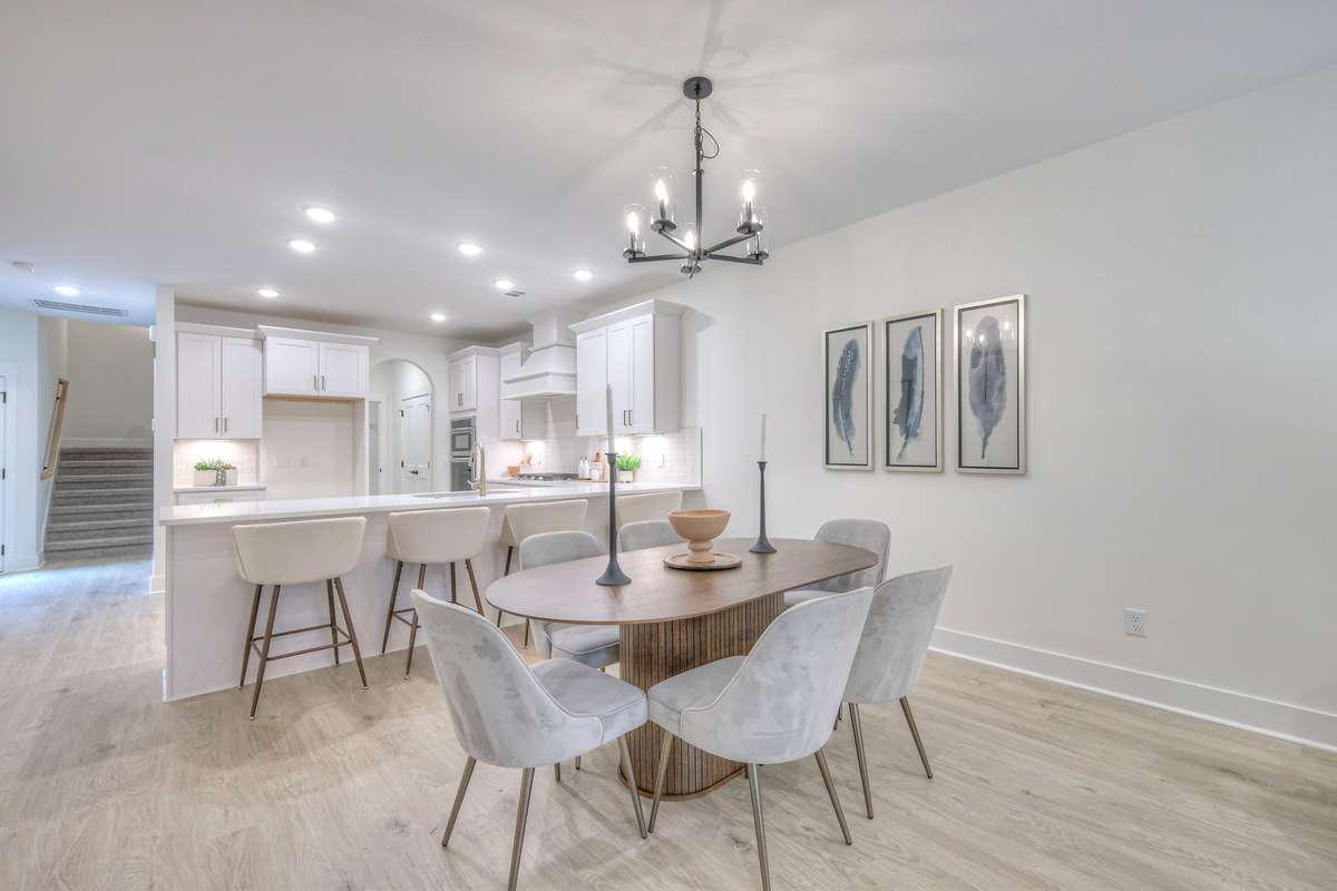 **Photos not of the actual home but of another Ashleigh floor plan in The Knoll at Fairvue. Pictures to show the layout of the living room and dining room staged with furniture.**