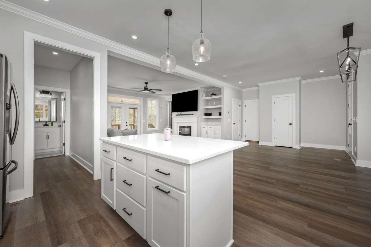 Standing at the island, you’re still part of the living room with the fireplace in view.