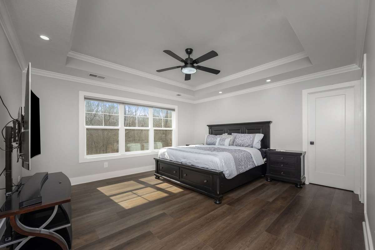 Comfortable and spacious primary bedroom featuring a private bath and generous closet space.