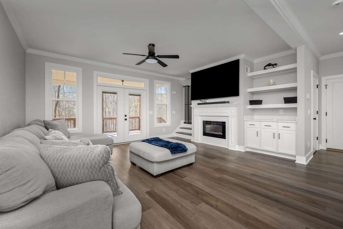 Bright living room with built-ins and a seamless flow to the covered outdoor space.