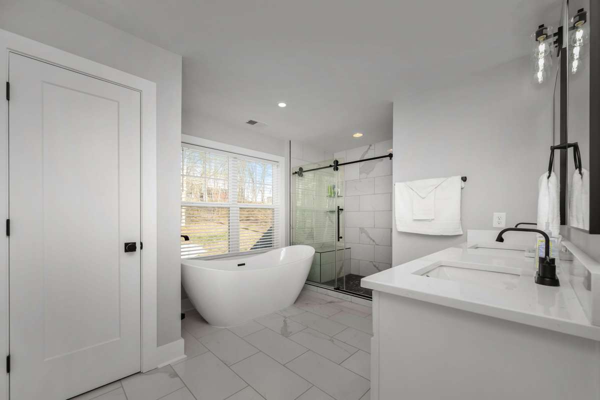 Plenty of space in this primary bathroom with dual sinks, large shower with seating, and a soaking tub to unwind.