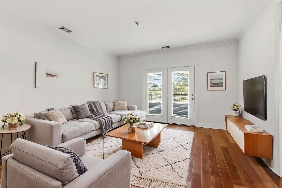 Virtually staged living room to the balcony