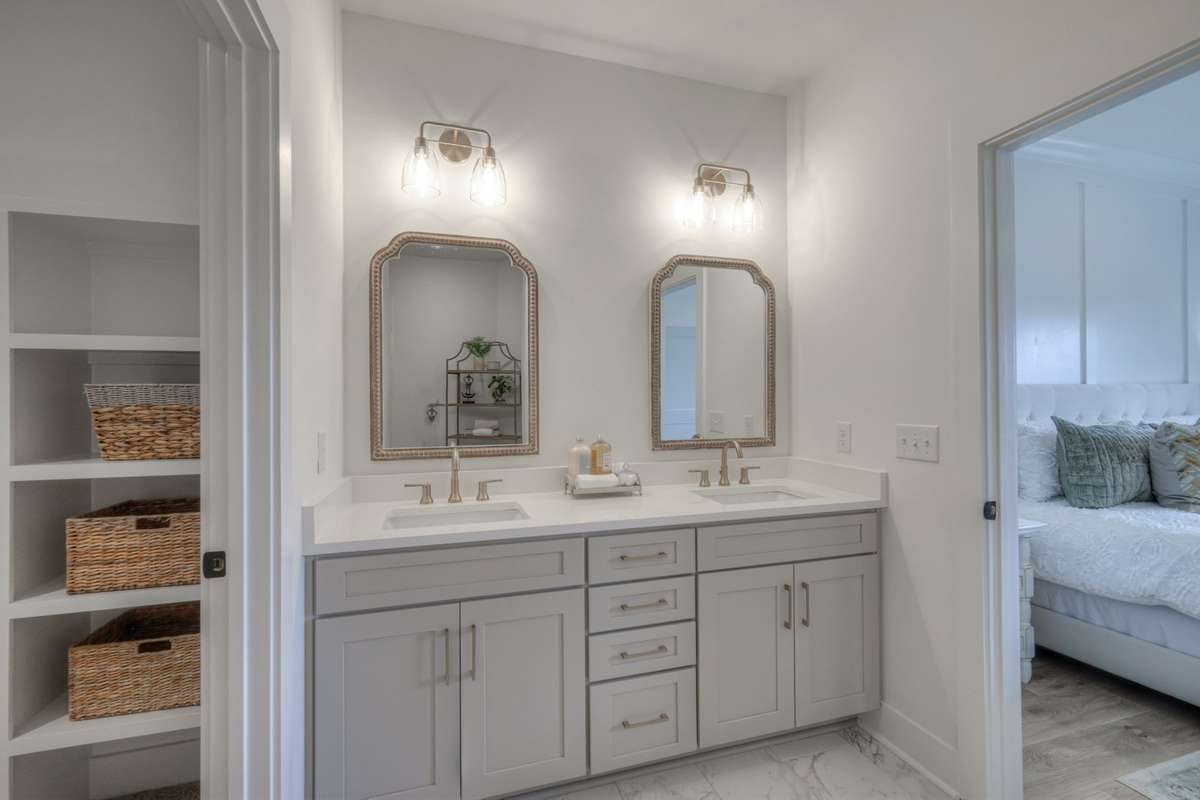 **Photos of the model home owners bathroom on the main level to show the layout of the floor plan staged with furniture. Not the actual house.**