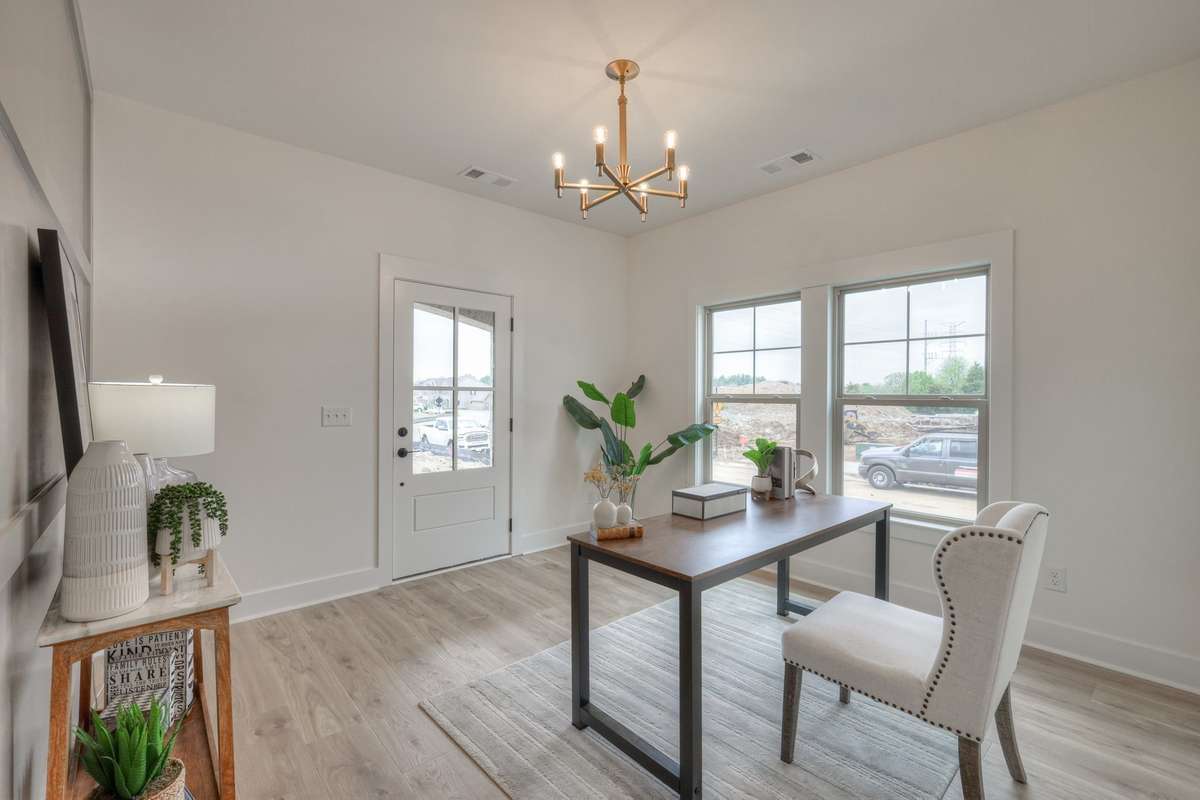 **Photos of the model home office on the main level to show the layout of the floor plan staged with furniture. Not the actual house.**