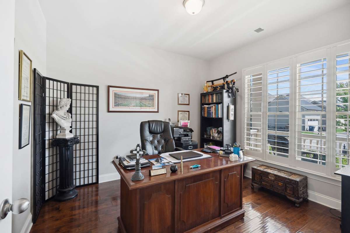 Bedroom #3 with large 4 panel window, plantation shutters, hard wood floors, and double door closet. Owners currently using as office space.