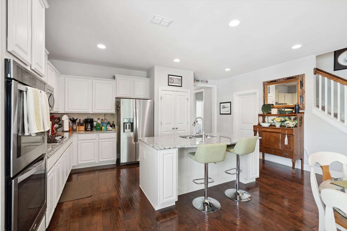 You will also find a double door pantry, white cabinetry, and tile backsplash.