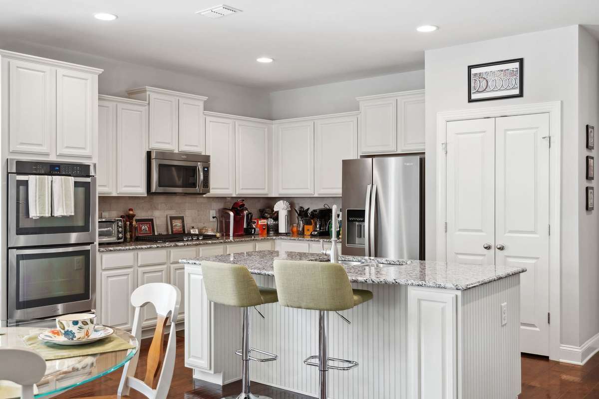 The kitchen also features stainless steel appliances (Double Ovens, Dishwasher, built-in microwave, and Fridge).