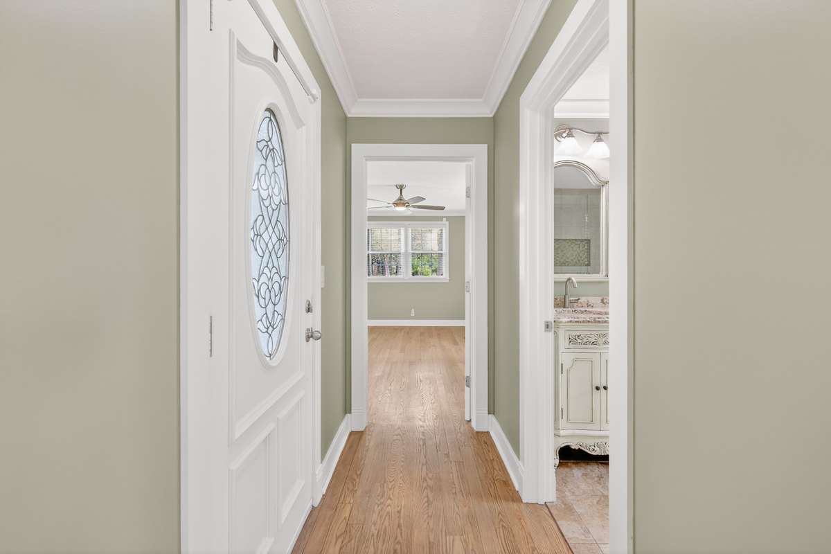 HALLWAY WITH MASTER BATH ON THE RIGHT AND PATIO ACCESS TO THE LEFT