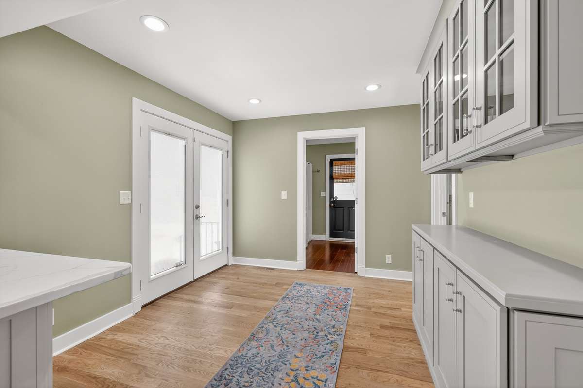 LAUNDRY AND FULL BATH WITH DOOR LEADING TO ALCOVE/PATIO