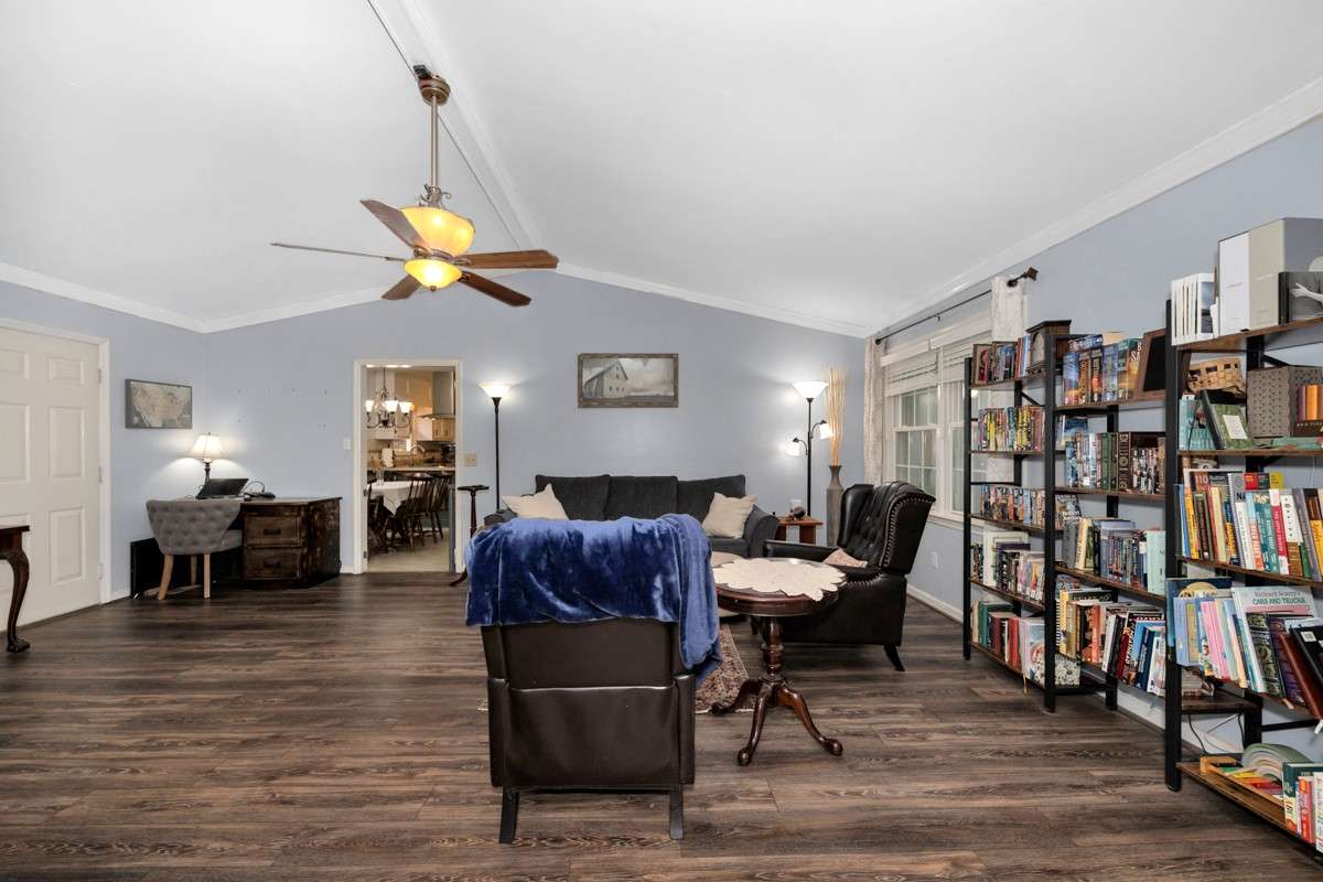 Living Room- LVP flooring, crown molding. vaulted ceiling, ceiling fan, gas log fireplace