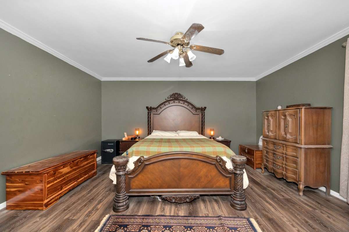 Primary Bedroom-LVP flooring, crown molding, ceiling fan