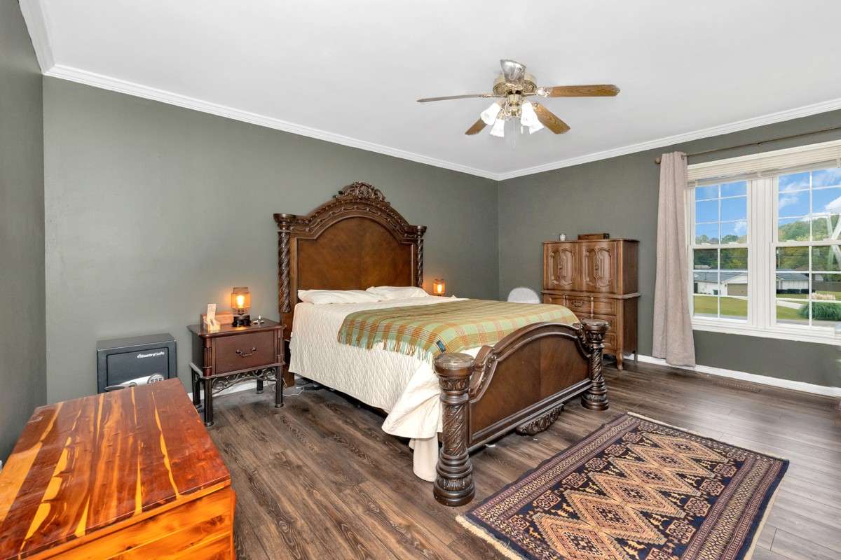 Primary Bedroom-LVP flooring, crown molding, ceiling fan