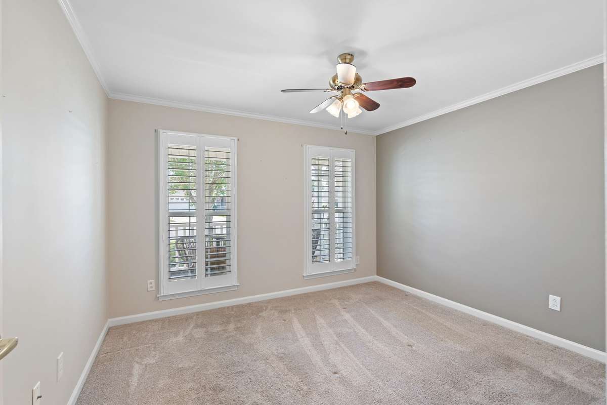 Lovely views overlooking the charming front porch from the second bedroom!