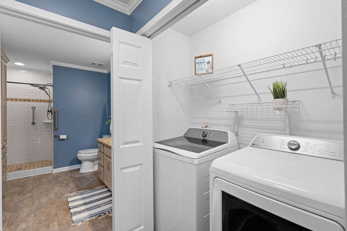 Ultimate convenience! Laundry area with extra shelving for organization, situated just steps from the primary suite.