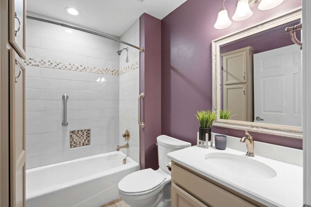 Stylish tub/shower combo with classic subway tile and custom mosaic detail!